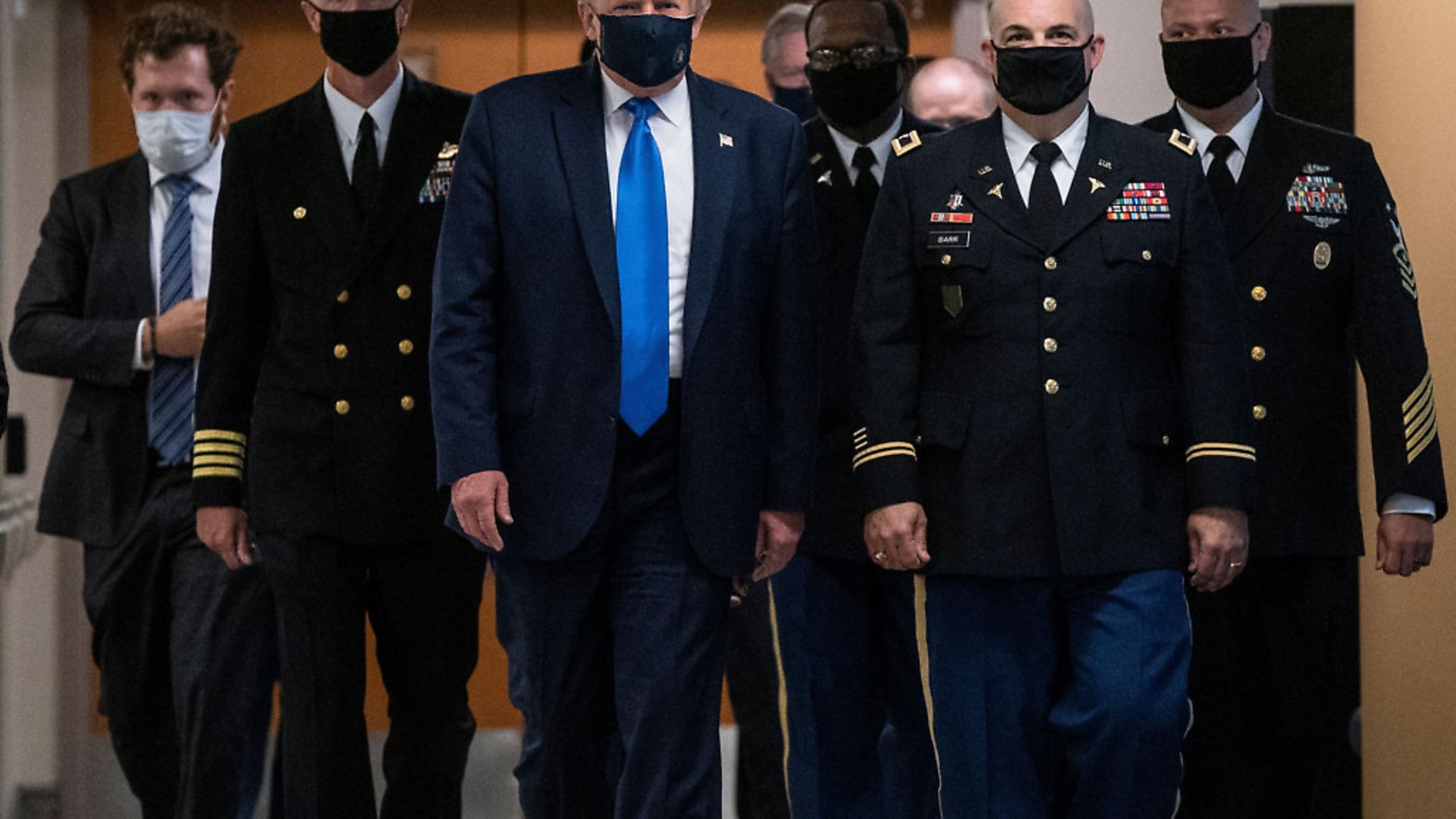 US President Donald Trump wears a mask as he visits Walter Reed National Military Medical Center in  Maryland. Photo: ALEX EDELMAN/AFP via Getty Images - Credit: AFP via Getty Images