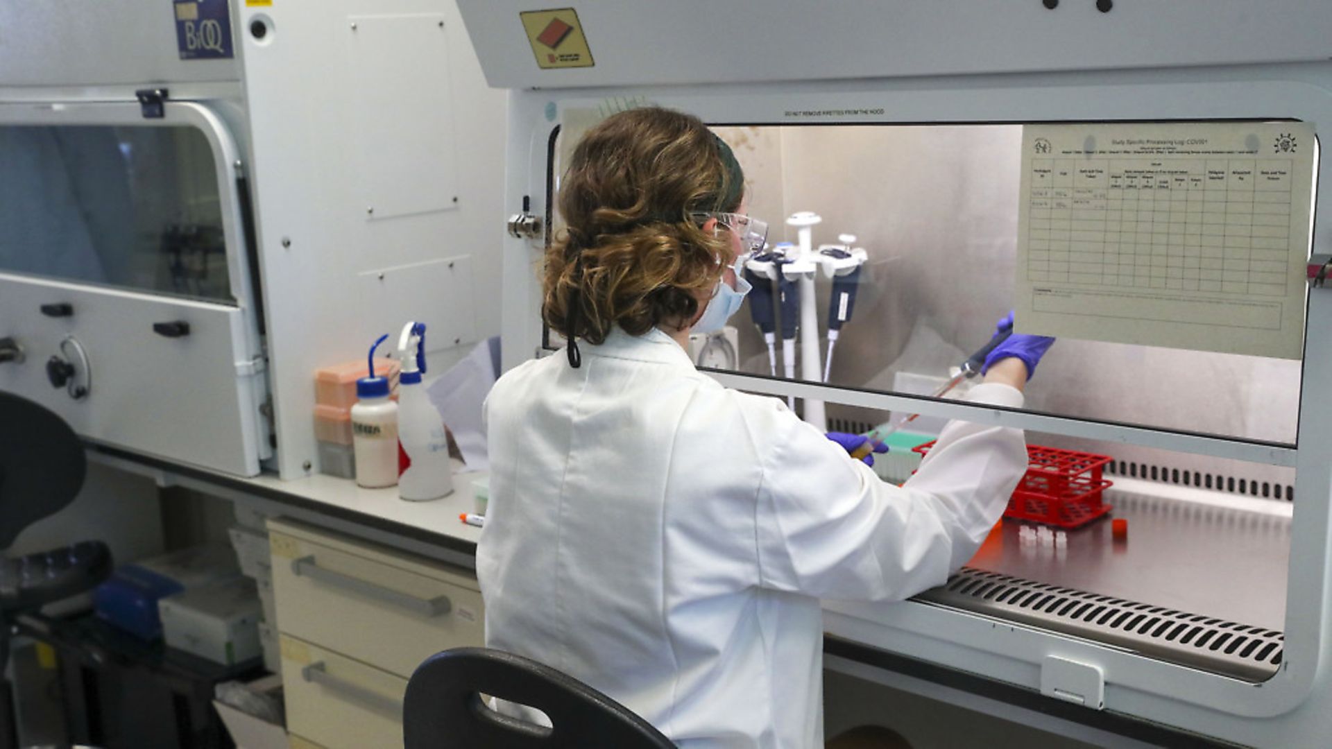 A scientist at work in a manufacturing laboratory where a vaccine against COVID-19 has been produced at the Oxford Vaccine Group's facility at the Churchill Hospital in Oxford. Photograph: Steve Parsons/PA. - Credit: PA