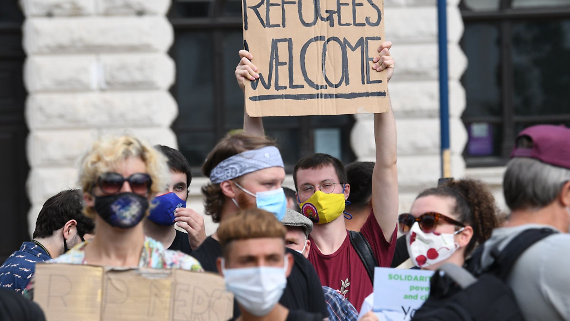 Pro-migrant supporters during a 'solidarity stand' in Dover's Market Square in support of the refugees crossing the Channel to Kent. Photograph: Stefan Rousseau/PA. - Credit: PA
