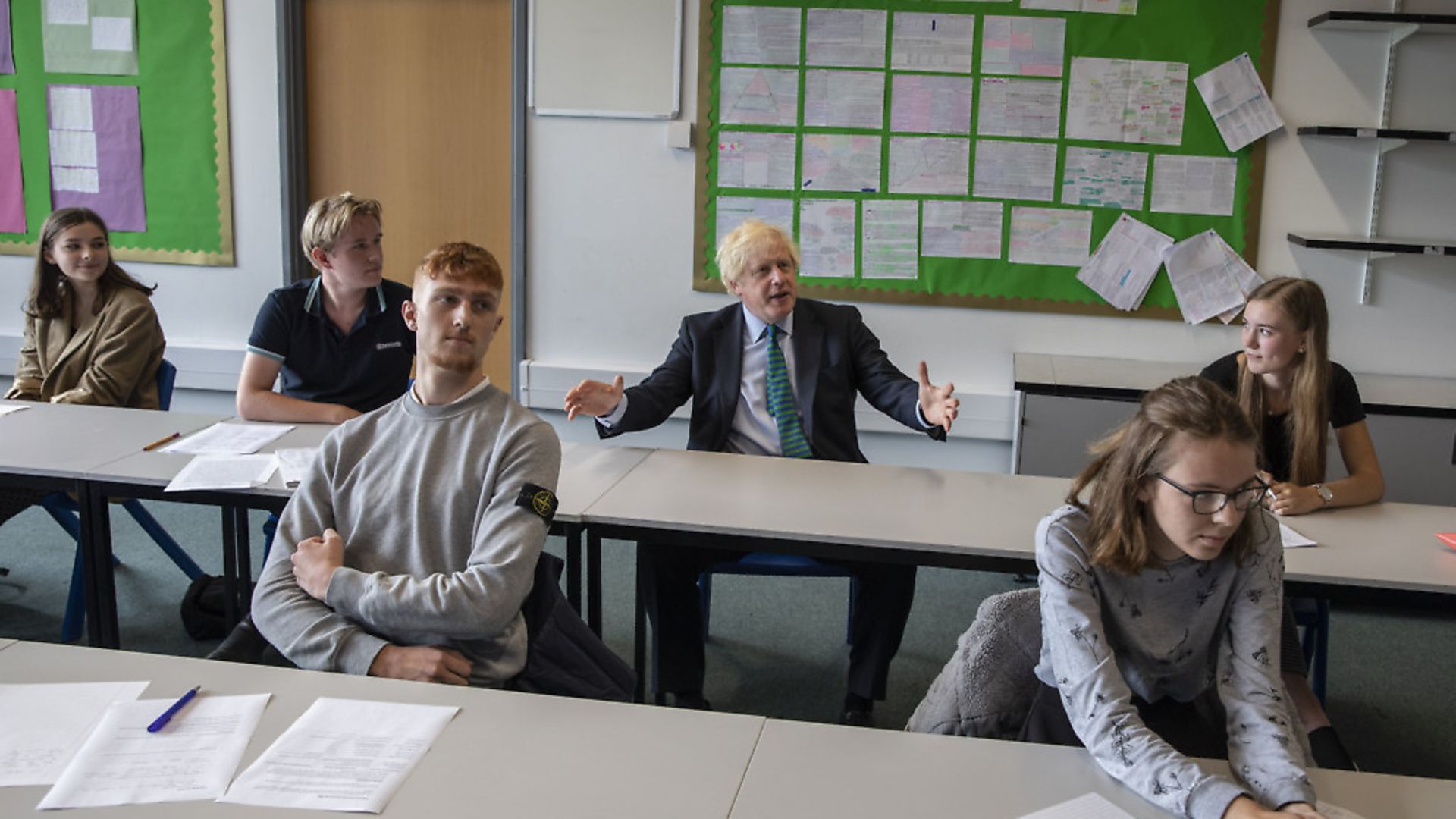 Prime Minister Boris Johnson with year 11 pupils as he tours Castle Rock school, Coalville, in the east Midlands. Photograph: Jack Hill/The Times. - Credit: PA