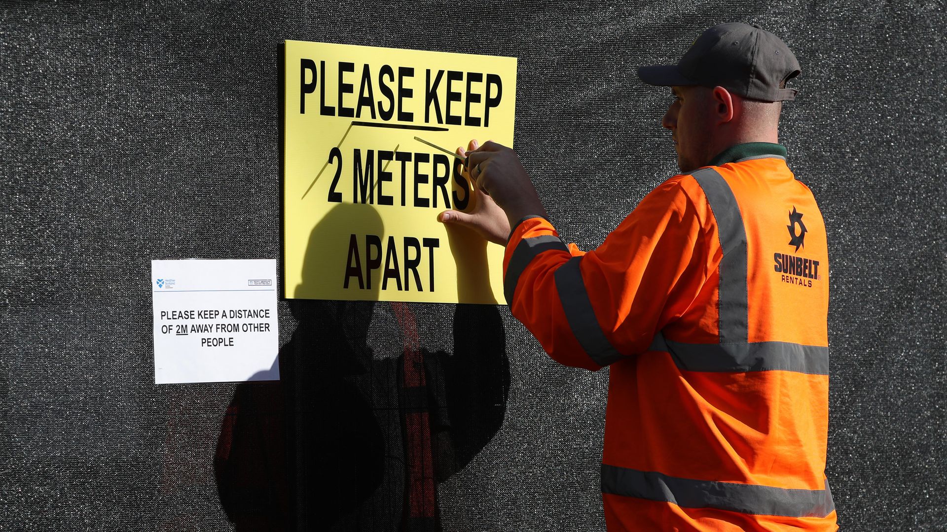 A sign is put up at the new walk-through testing centre which will open today at Glasgow Caledonian University's ARC sports centre, in central Glasgow. - Credit: PA