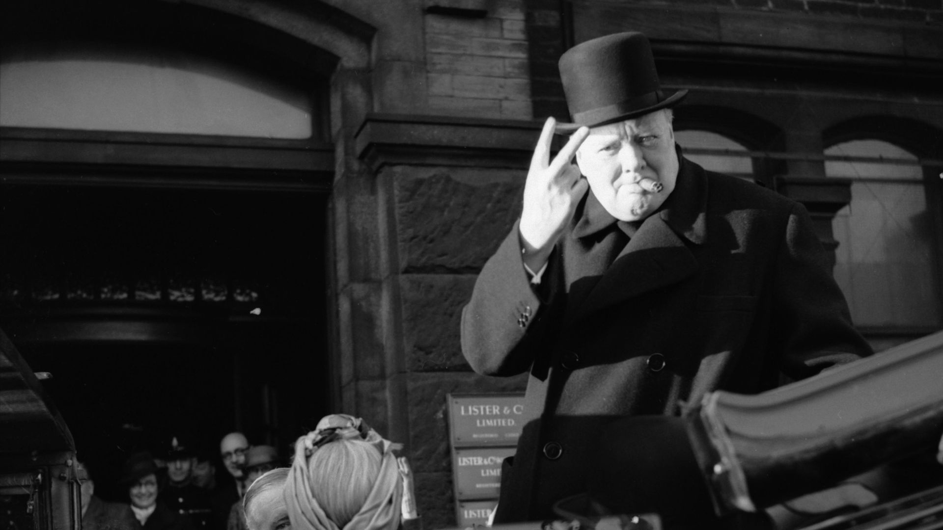 Winston Churchill gives his famous 'V' sign during a visit to Bradford in December 1942 - Credit: Imperial War Museums via Getty I