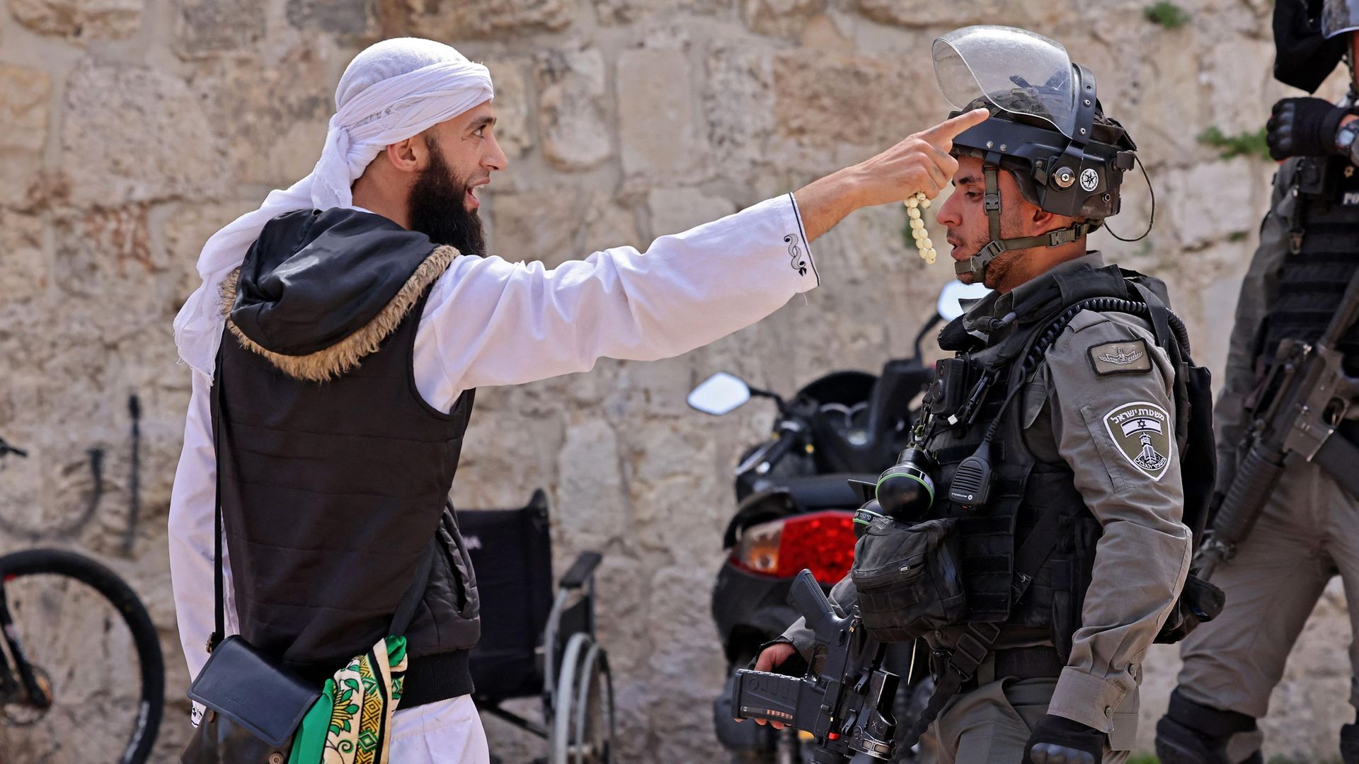 A Palestinian argues with an Israeli soldier in Jerusalem's Old City - Credit: AFP via Getty Images