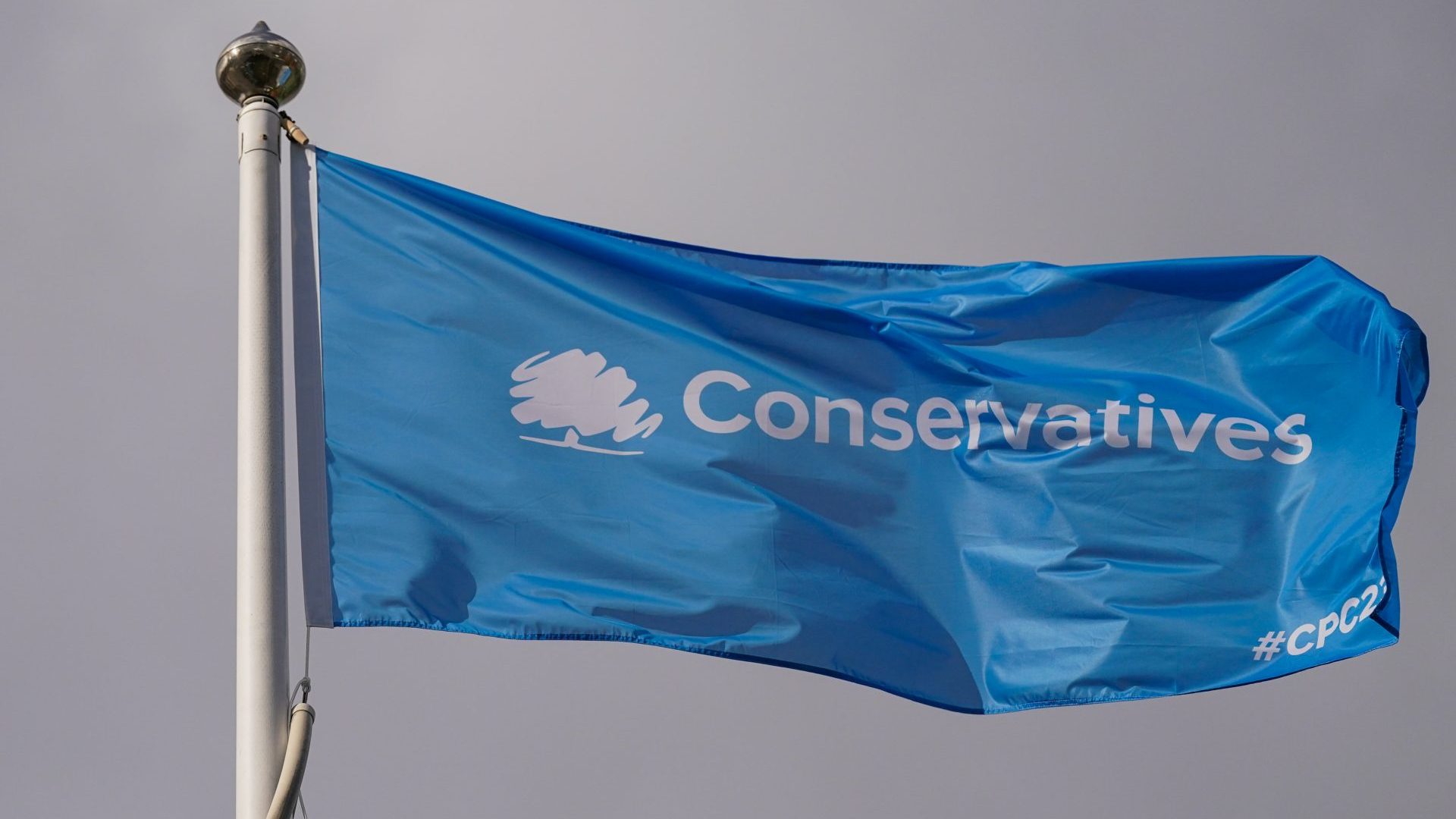 A conservative party flag flies over the conference venue on the third day of the Conservative Party Conference (Photo by Ian Forsyth/Getty Images)
