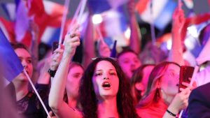 Supporters fly French flags in Hénin-Beaumont, northern France, after the first round of voting in the general election saw Marine Le Pen’s far right Rassemblement National storm into first place. Photo: François Lo Presti/AFP/Getty