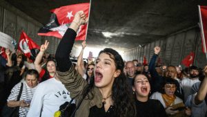 Protesters shout slogans as they march through a tunnel after attending a rally called by the Republican People's Party (CHP) in support of Istanbul's arrested mayor Ekrem Imanoglu. Photo: ED JONES/AFP via Getty Images