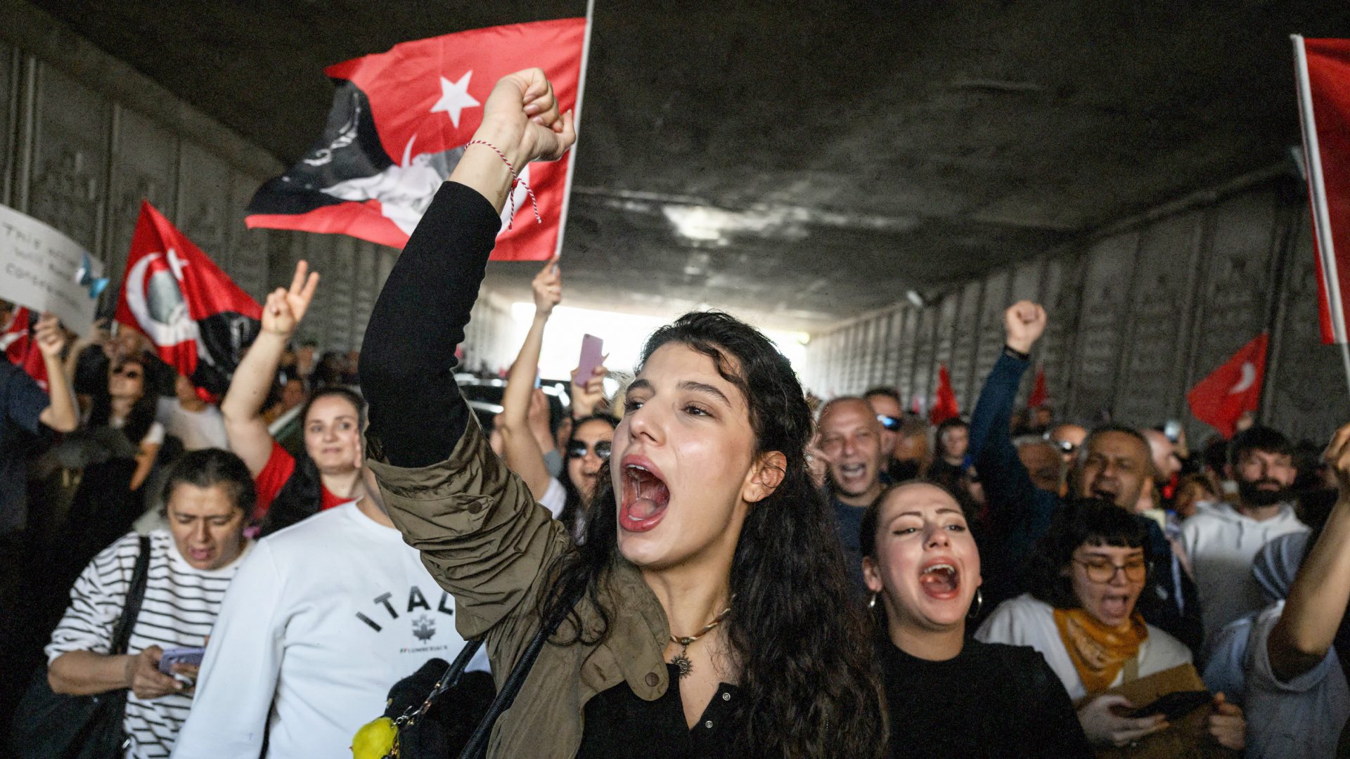 Protesters shout slogans as they march through a tunnel after attending a rally called by the Republican People's Party (CHP) in support of Istanbul's arrested mayor Ekrem Imanoglu. Photo: ED JONES/AFP via Getty Images