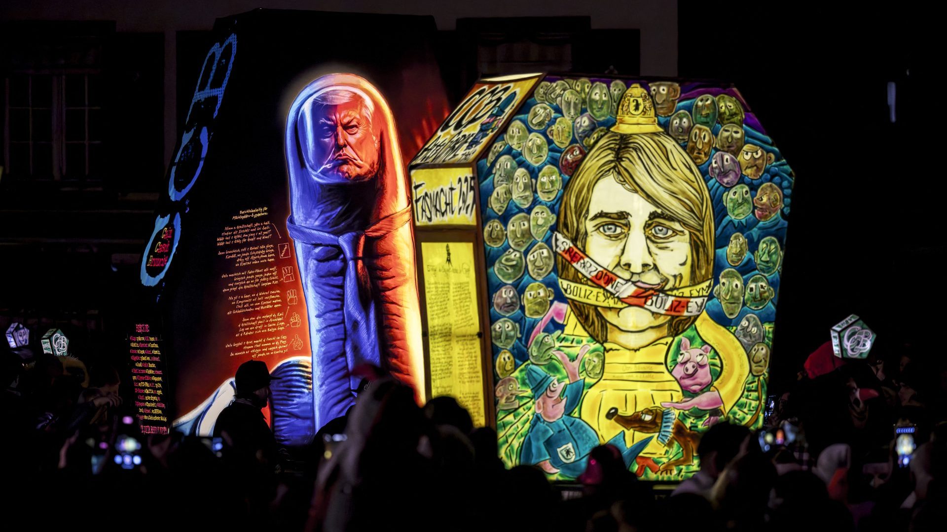 Hand-painted lanterns depicting Donald Trump and Basel-Stadt Councillor Stephanie Eymann are seen during the traditional "Morgenstreich" procession starting the carnival of Basel. Photo: FABRICE COFFRINI/AFP via Getty Images