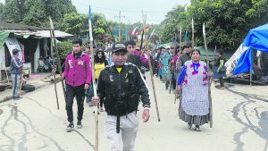 Supporters of Evo Morales parade through the streets of Lauca Ñ, where they are protecting the former president from an arrest order. Photo: Thomas Graham
