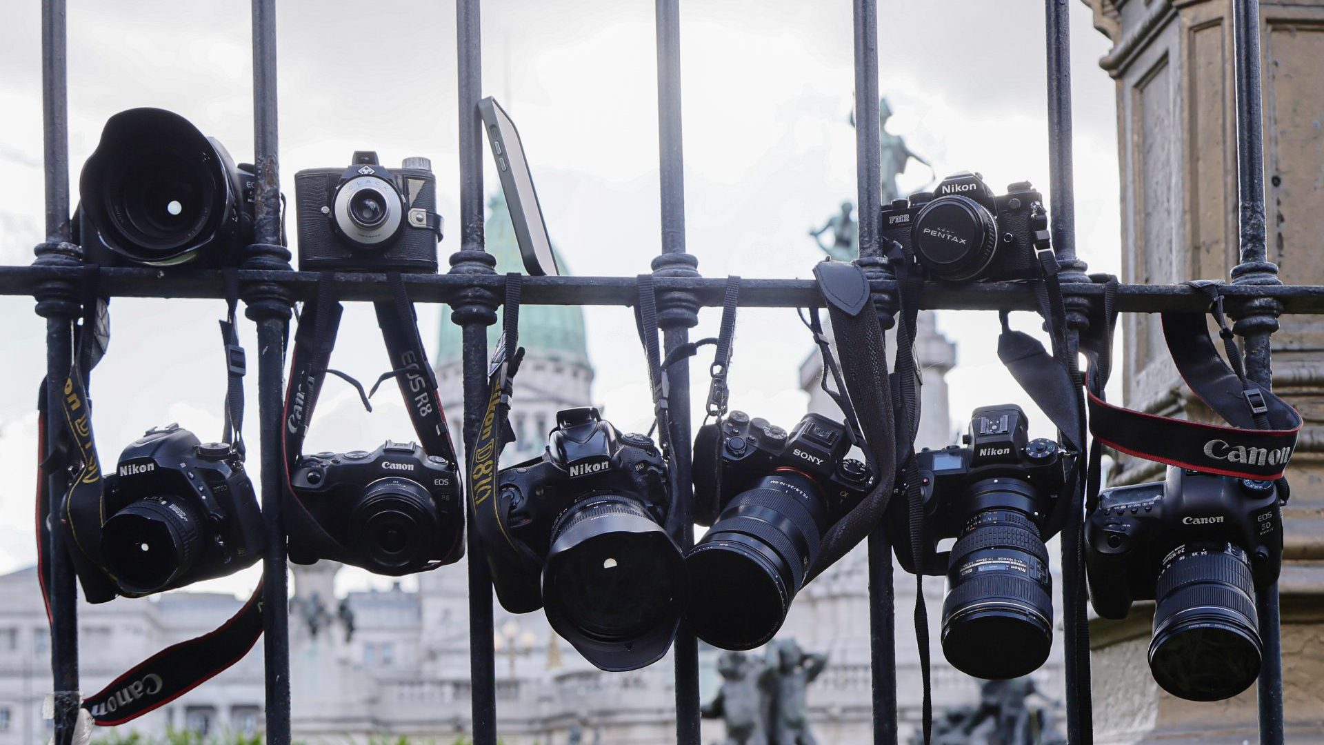 Journalists gather outside Argentina’s National Congress in Buenos Aires, hanging cameras on its gates in protest after photojournalist Pablo Grillo was critically injured while covering a demonstration, on March 13. Photo: Luciano González/Anadolu/Getty