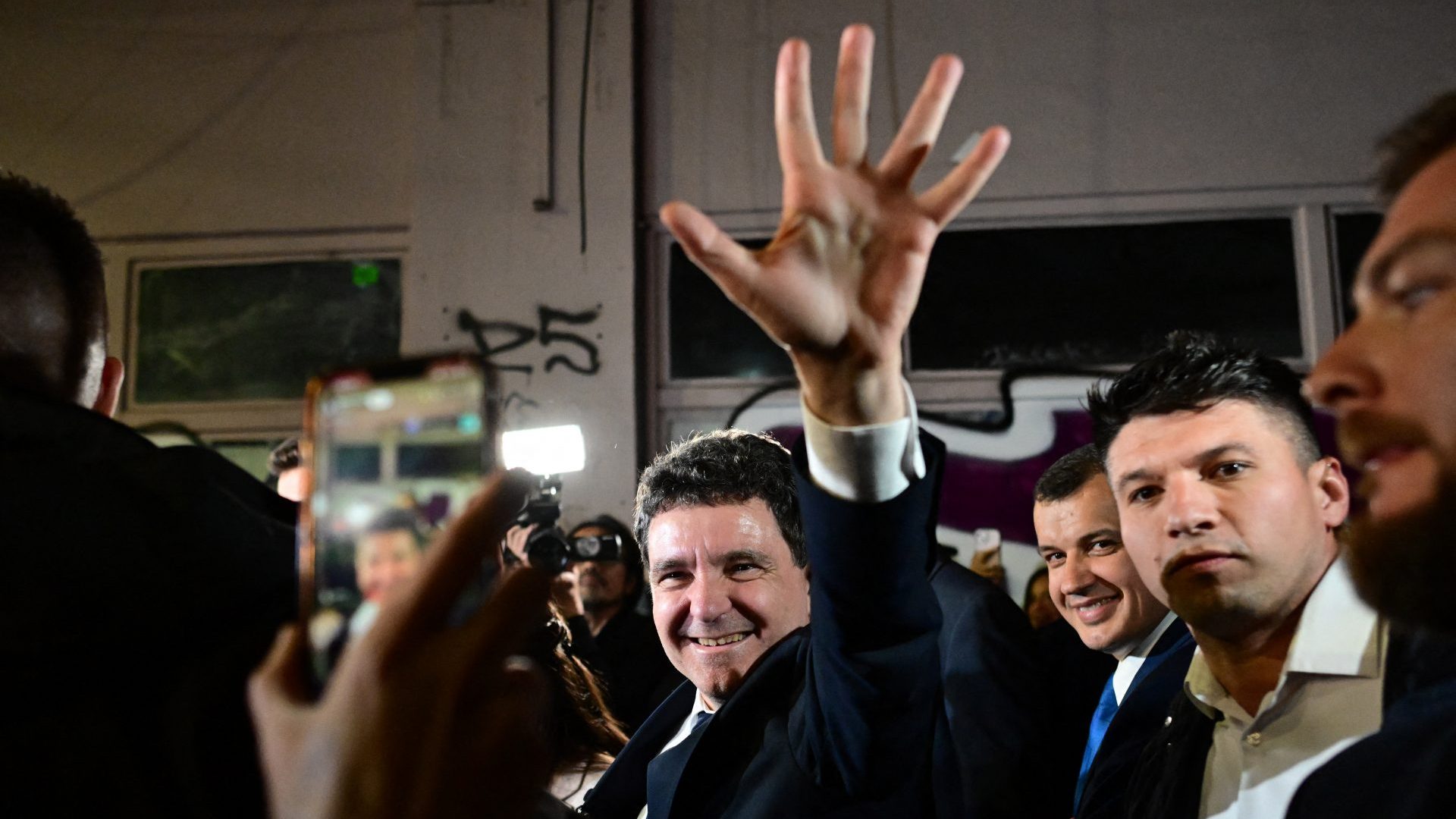 Nicuşor Dan salutes his supporters as he leaves his campaign headquarters in Bucharest, May 18, 2025. Photo: Daniel Mihailescu/AFP/Getty