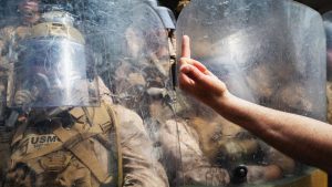 Protesters confront U.S. Marines outside of a federal building during an anti-Trump "No Kings Day" demonstration.  Photo: Spencer Platt/Getty Images