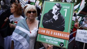 Supporters of the band Kneecap, and its singer Liam O'Hanna who performs under the stage name Mo Chara, hold placards as they gather outside Westminster Magistrates' Courts. Photo: BENJAMIN CREMEL/AFP via Getty Images