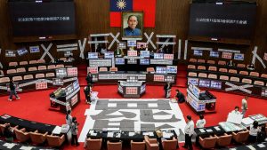 A poster reading ‘recall’ and banners reading ‘Illegal meeting, invalid resolution’ in the Legislative Yuan chamber in Taipei. Image: I-Hwa Cheng/AFP/Getty