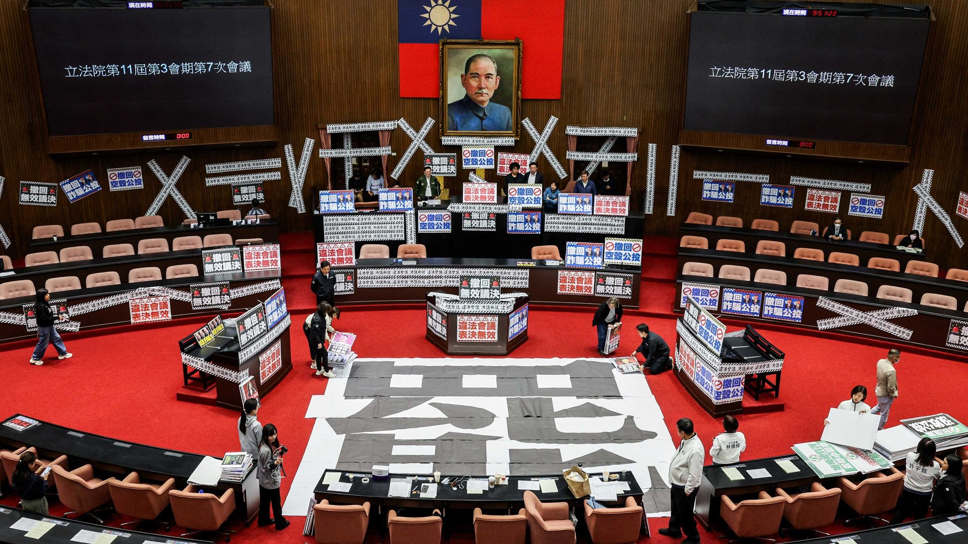A poster reading ‘recall’ and banners reading ‘Illegal meeting, invalid resolution’ in the Legislative Yuan chamber in Taipei. Image: I-Hwa Cheng/AFP/Getty