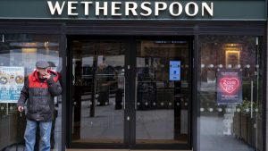 A customer enjoys a cigarette outside a Wetherspoon pub in Elephant and Castle, South London. Photo: Mike Kemp/In Pictures via Getty Images