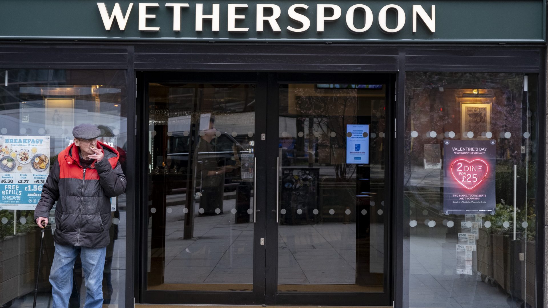 A customer enjoys a cigarette outside a Wetherspoon pub in Elephant and Castle, South London. Photo: Mike Kemp/In Pictures via Getty Images