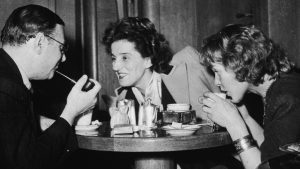 Philosopher Jean-Paul Sartre talks to two women at the Pont Royal in Paris, 1964. IMAGE: Getty