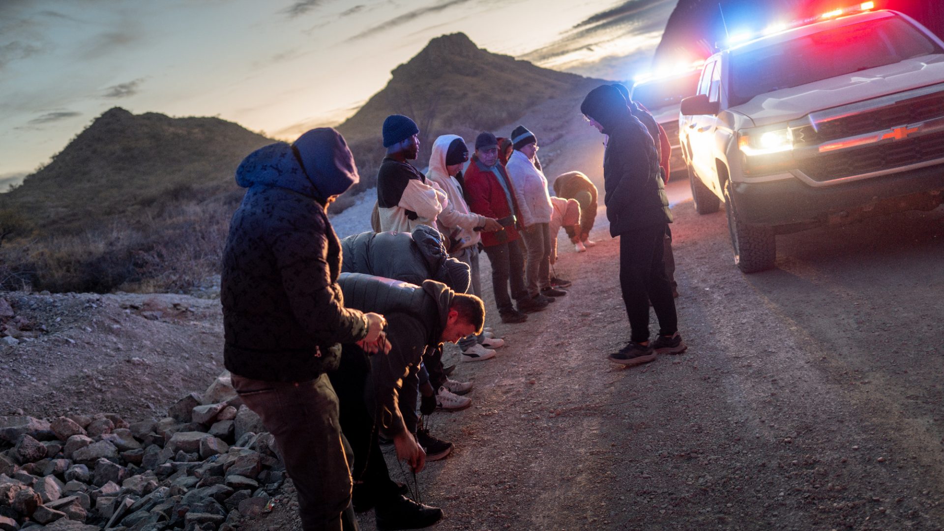 Migrants from Mexico and Guatemala are apprehended by US Customs and Border Patrol officers after crossing a section of border wall into the US near Ruby, Arizona. Image: Brandon Bell/Getty