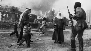 A Palestinian woman pleads with Christian militia in Beirut while a man tries to take children to safety during the Lebanese civil war, January 19, 1976. This image won the World Press Photo award. Image: Françoise Demulder/Roger Viollet/Getty
