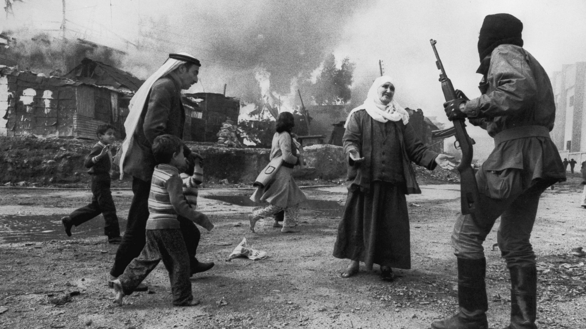 A Palestinian woman pleads with Christian militia in Beirut while a man tries to take children to safety during the Lebanese civil war, January 19, 1976. This image won the World Press Photo award. Image: Françoise Demulder/Roger Viollet/Getty
