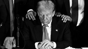 Donald Trump prays during a roundtable discussion with Latino community leaders at Trump National Doral Miami. Photo: CHANDAN KHANNA / AFP) (Photo by CHANDAN KHANNA/AFP via Getty Images