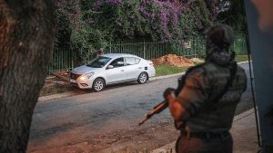 A security guard in Johannesburg questions a driver. image: MICHELE SPATARI/AFP