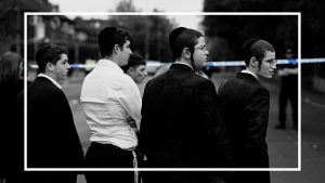 Members of the local community stand by a police cordon near to Heaton Park Hebrew Congregation synagogue in Crumpsall, north Manchester. Photo: OLI SCARFF/AFP via Getty Images