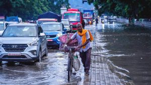People's daily lives are affected by heavy rainfall and water overflowing onto the roads during the monsoon in Lalitpur, Nepal. Photo: Ambir Tolang/NurPhoto via Getty Images