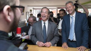 Nigel Farage laughs while visiting a vape shop with Nathan Gill on Merthyr Tydfil's High Street in 2019. Photo: Matthew Horwood/Getty Images