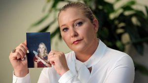 Virginia Giuffre, with a photo of herself as a teen, when she says she was abused by Jeffrey Epstein, Ghislaine Maxwell and Prince Andrew, among others. Photo: Emily Michot/Miami Herald/Tribune News Service via Getty Images