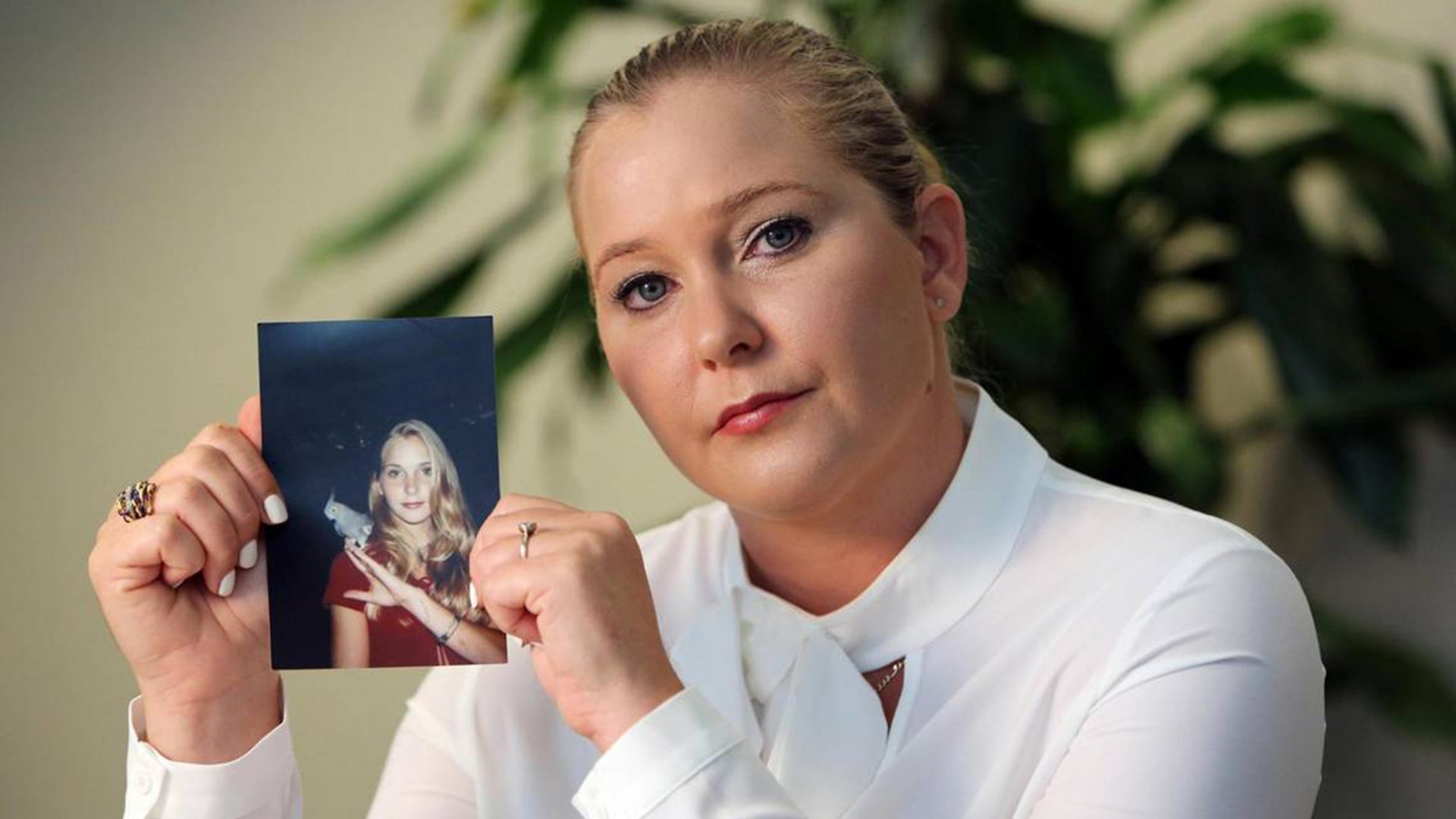 Virginia Giuffre, with a photo of herself as a teen, when she says she was abused by Jeffrey Epstein, Ghislaine Maxwell and Prince Andrew, among others. Photo: Emily Michot/Miami Herald/Tribune News Service via Getty Images