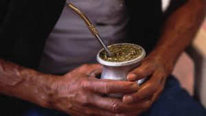 A rural worker holds an infusion of 'Mate' with his hands in the Yerba Mate Trade Union Workers as part of the production of the Yerba Mate herb. Photo: Ricardo Ceppi/Getty Images