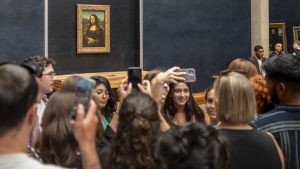 A crowd of tourists take selfies in front of Leonardo da Vinci’s Mona Lisa in the Louvre, Paris. Image: Antoine Boureau/Hans Lucas/AFP