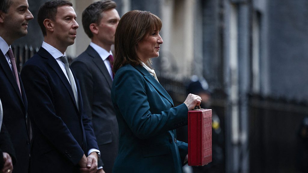 Chancellor Rachel Reeves poses with the red Budget Box as she leaves 11 Downing Street. (Photo by Henry NICHOLLS / AFP via Getty Images)