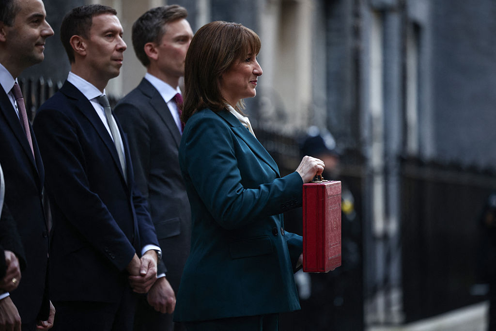 Chancellor Rachel Reeves poses with the red Budget Box as she leaves 11 Downing Street. (Photo by Henry NICHOLLS / AFP via Getty Images)