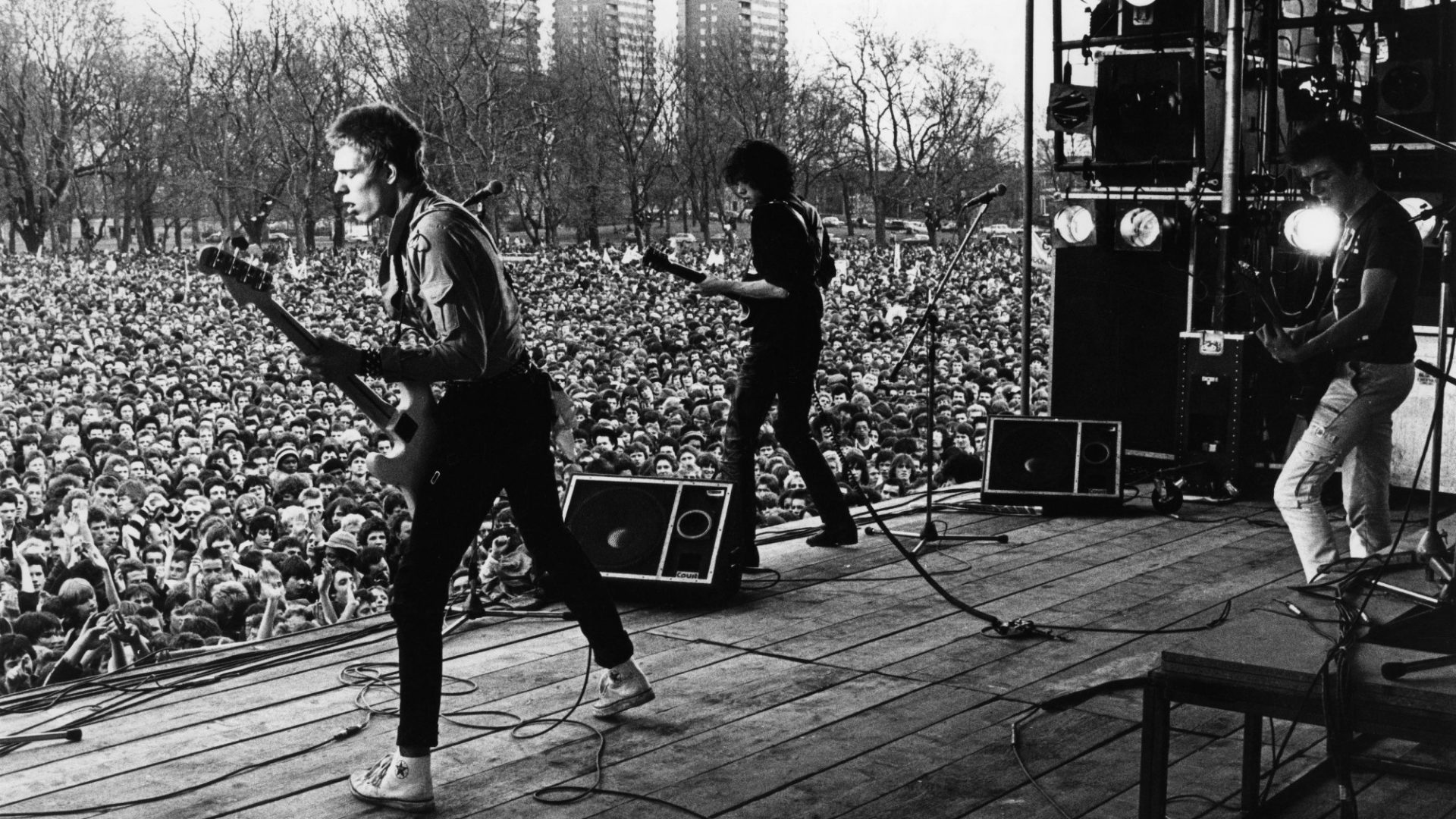 Paul Simonon, Mick Jones and Joe Strummer of The Clash on stage at the Rock Against Racism carnival in Victoria Park, Hackney, April 30, 1978. Image: Val Wilmer/Redferns/Getty