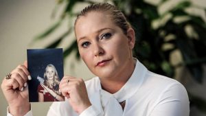 The late Virginia Giuffre in 2022, with a photo of herself as a teenager. Photo: Image: Emily Michot/Miami Herald/Tribune News Service/Getty
