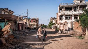 Women walk through a war-torn neighborhood in Omdurman. Sudan's war erupted in April 2023 between the regular army led by Burhan and the paramilitary Rapid Support Forces (RSF), led by his former deputy, Mohamed Hamdan Daglo. Photo: AMAURY FALT-BROWN/AFP via Getty Images 