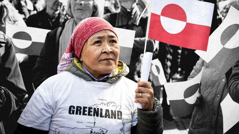 A woman holds a Greenland flag