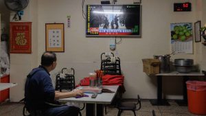 A man watches TV news coverage of the Chinese People's Liberation Army (PLA) military drills around Taiwan in Keelung. Photo: CHENG Yu-chen / AFP via Getty Images