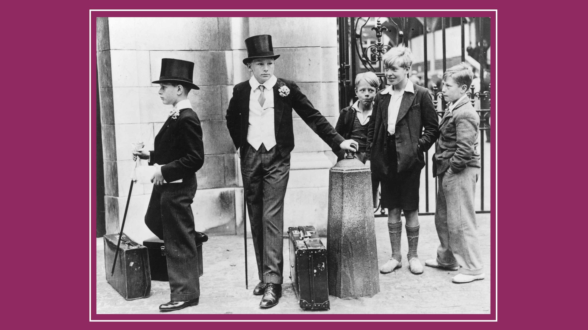 A group of local boys look on with curiosity and amusement at two Harrow schoolboys in their formal uniform at the Eton v Harrow cricket match on 9 July 1937 at Lord's cricket ground, London. Image: Jimmy Sime/Central Press/Hulton Archive/Getty