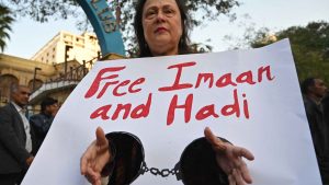 A woman holds a placard as she takes part in a protest against the arrest of rights activist Imaan Mazari and her husband, fellow lawyer Hadi Ali Chattha. Photo: Asif HASSAN / AFP via Getty Images