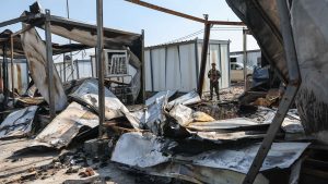 A member of Kurdistan Freedom Party (PAK) stand next to the damaged containers at their military base after Iranian drone attack on March 9, 2026 in Erbil, Iraq. Photo: Sedat Suna/Getty Images
