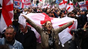 Supporters of Tommy Robinson attend a ‘Uniting the Kingdom’ march in central London, October 2024. Image: HENRY NICHOLLS / AFP/Getty