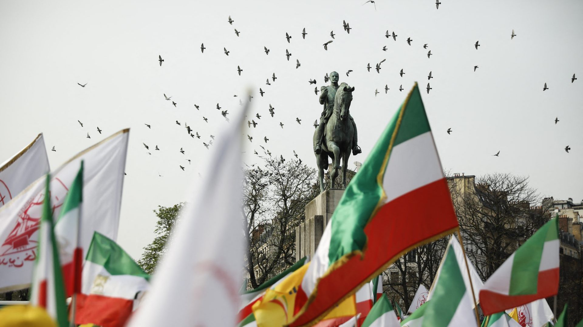 Demonstrators wave Iranian flags during a rally at Trocadéro Square in Paris on March 7. Image: LAURE BOYER/HANS LUCAS/AFP/GETTY