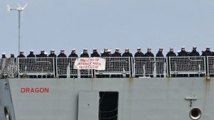 Crew members line the deck of HMS Dragon, a Royal Navy warship, as it leaves Portsmouth on March 10, sailing for the eastern Mediterranean to bolster British defences. IMAGE: JUSTIN TALLIS/AFP/GETTY