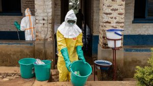 A health worker disinfects a hospital in Mongbwalu, Democratic Republic of Congo, during Ebola response operations. Image: Michel Lunanga/Getty
