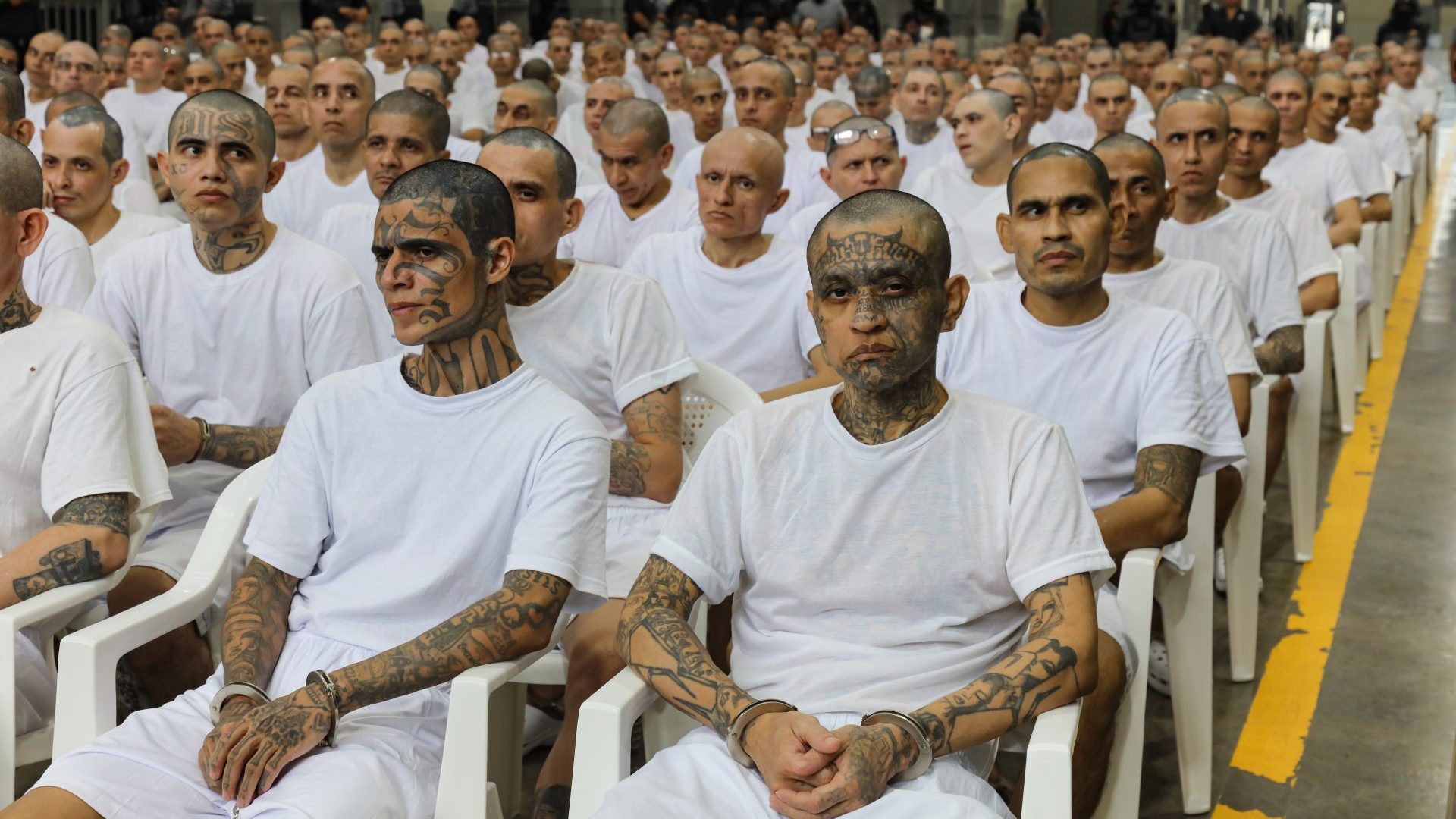 Prisoners attend a massive hearing against criminals and gang members at the Cecot mega-prison on April 23 in Tecoluca, El Salvador. Image: Alex Peña/Getty
