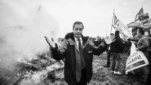 Nigel Farage stands beside the remains of a small boat on top of a bonfire during a demonstration against the Brexit transition deal in Whitstable, April 2018. Image: Niklas Halle'n/AFP/Getty Images
